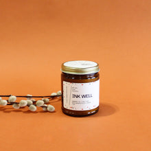 Load image into Gallery viewer, INK WELL Hand Poured Candle. Ambrette. Red Grapefruit. Sea Salt. Sage. Traditional Cotton Wick. Amber Jar.