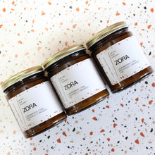 Load image into Gallery viewer, ZORA Hand Poured Candle. Lavender. Pine. Orange. Lemongrass. Cashmere. Musk. 7 oz. Traditional Cotton Wick. Amber Jar.