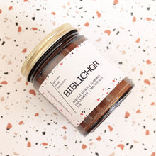 Load image into Gallery viewer, BIBLICHOR Hand Poured Candle. Aged Leather. Mahogany. Parchment. Almond Crema. Vanilla. Sandalwood. Library Scent. Books. Traditional Cotton Wick. Amber Jar.