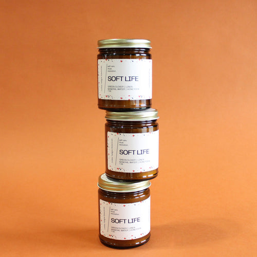 SOFT LIFE Hand Poured Candle. Green Clover. Clean Cotton. Honeydew. Lily of the Valley. Traditional Cotton Wick. Amber Jar.