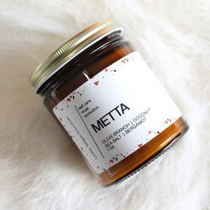 METTA Hand Poured Candle. Olive Branch. Coconut. Bergamot. Cassis. Coriander. Salt Air. Thyme. 7 oz. Traditional Cotton Wick.