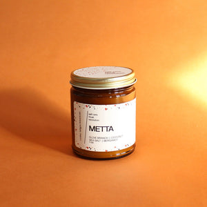 METTA Hand Poured Candle. Olive Branch. Coconut. Bergamot. Cassis. Coriander. Salt Air. Thyme. 7 oz. Traditional Cotton Wick.