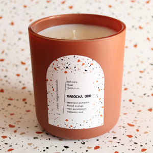 KABOCHA OUD Hand Poured Candle. Blood Orange. Japanese Kabocha Pumpkin. Allspice. Brown Sugar. Wood Wick. 12 oz. Matte Terracotta.