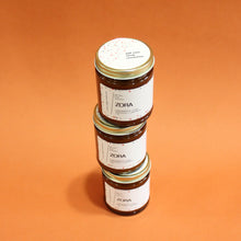 Load image into Gallery viewer, ZORA Hand Poured Candle. Lavender. Pine. Orange. Lemongrass. Cashmere. Musk. 7 oz. Traditional Cotton Wick. Amber Jar.