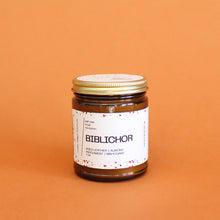 Load image into Gallery viewer, BIBLICHOR Hand Poured Candle. Aged Leather. Mahogany. Parchment. Almond Crema. Vanilla. Sandalwood. Library Scent. Books. Traditional Cotton Wick. Amber Jar.